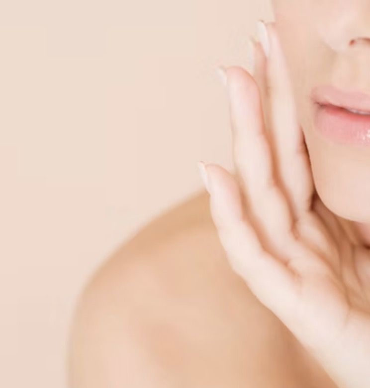 Woman gently touching her jaw